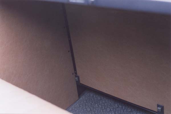 The rumble seat side cardboards were attached to the rear of the front seat on Roadsters only. The black angle bracket was riveted to the side cardboard with black enameled 9/64" tubular rivets. The assembly was then fastened to the rear of the seat with three black enameled round head screws. The seat was attached to the three angle brackets with 3/16" x 1/2" unfinished square nuts and lock washers.