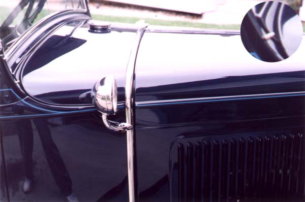 The inset image shows (poorly) the painted lead spacer that was used between the ends of the dashrail finish panel and the inside edges of the lower stanchion. This looked like a trim welt and acted as an anti-squeak. The lead anti-squeak replace a painted artificial leather version approximately April 1930. The beltline on the hood aligns well with the body. The original lacing or hood pad around the firewall was thinner than modern replacements allowing the hood to lay down and reach the proper location.