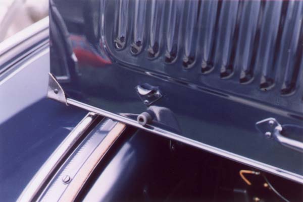 The hood rubbers prior to April '31 were 5/8" diameter x 1/2" deep and had a radiused outer end. The original leather hood corner had the seem running diagonally up the back side. It was either at 30° or 60° depending on which side of the car. The leather is thicker and firmer than modern upholstery leathers. Both items were attached with 9/64" dia. x 5/16" long tubular rivets finished in black enamel. Note the unbuffed satin finish paint on all but the outer surfaces. The smaller diameter rivet heads (approximately .285") are the easiest way for the novice to recognize an original hood. The differences in curvature are less obvious until familiar.