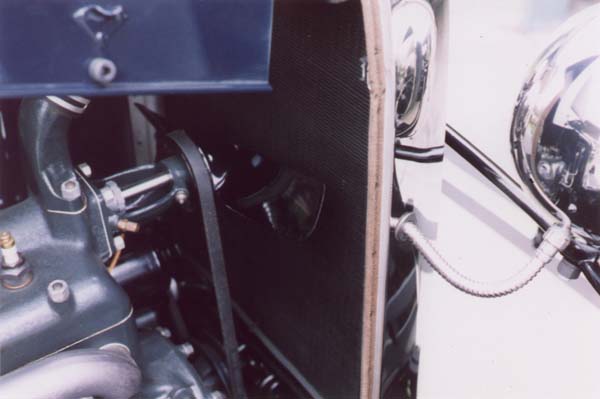 The exhaust manifold shows the grind marks where the casting seam or slag was ground off flush along the top. The original copper/asbestos clad manifold gaskets are nearly a perfect match to the diameters of the manifold, unlike the reproductions that are much larger. The edges of the gaskets are sheared clean and look exactly like the edges of the head gasket.
