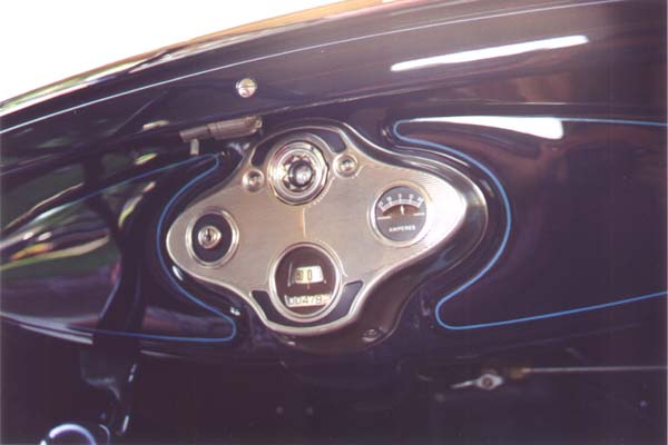 All the black items around the instrument panel are similarly satin. The ammeter has unpainted aluminum letters and markings on the face plate. The inside back of the ammeter was sprayed flat black so nothing bright or reflective was visible through the hole in the face plate.