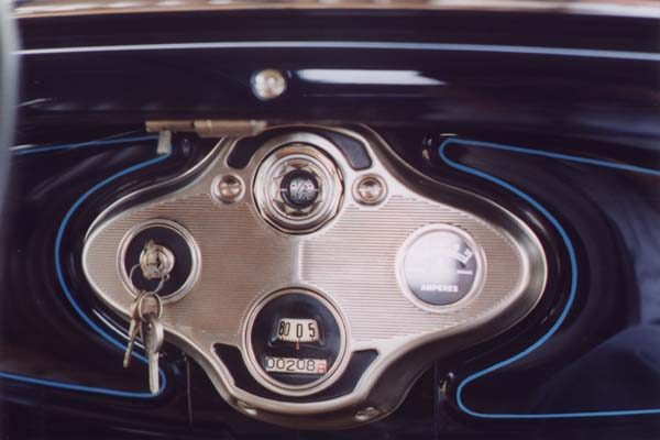 The upper and lower recesses in the instrument were painted satin black. The unpainted areas were protected from spray with a mask providing a feathered edge around the perimeter or the recesses instead of a tape ridge.