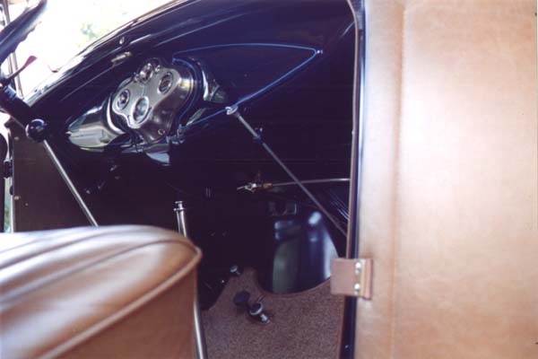 The carpet binding was finished at approximately 7/16" wide as viewed from the top. The binding was artificial leather matching the interior trim.