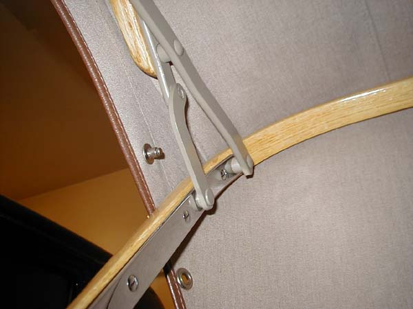 Another view of the folding irons. The rivets and spacers shown at all the hinge points are the originals. Fortunately they were restorable for reassembly. Note the "Cinch" stud fastener installed just above the rear bow. This is for attaching the quarter side curtain. This fastener is omitted from most restorations and all top kits I've seen.