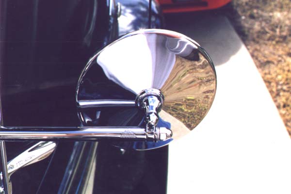 This original mirror is made by Trico and has their logo on the arm near the mirror. The version from Stant Manufacturing is nearly indistinguishable except for no markings. The lock washers under the acorn nuts are cadmium plated.