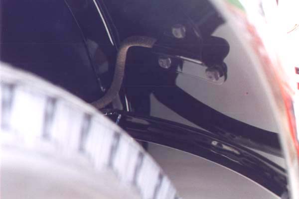 The rear fender brackets as well as the rear lamp brackets and plates were also dipped. The conduit for the rear lamp wires shown here is also original. The modern version is quite close.