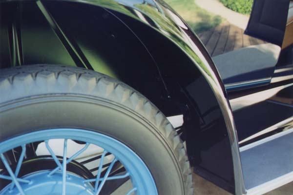 This is a later photo with the other set of wheels and new (and accurate) Goodyear tires installed. Both sets of wheels have original "R" (supplier) hubcaps and original Schrader valve stems and covers installed